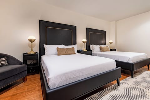 Bedroom 1 - Double queen beds featuring a built-in wardrobe and flat-screen TV.