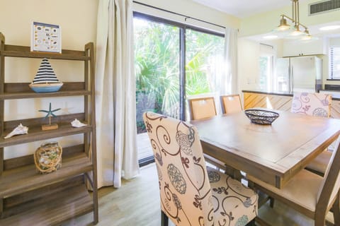 There are sliding glass doors in the dining area to access the side deck.