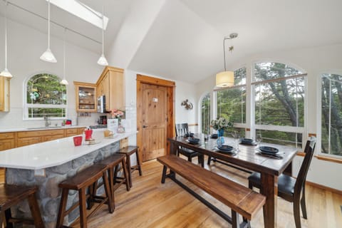 Open living space with,Kitchen with breakfast bar, dining room and  Living room with Gas fireplace, Roku TV, and access to upper deck.