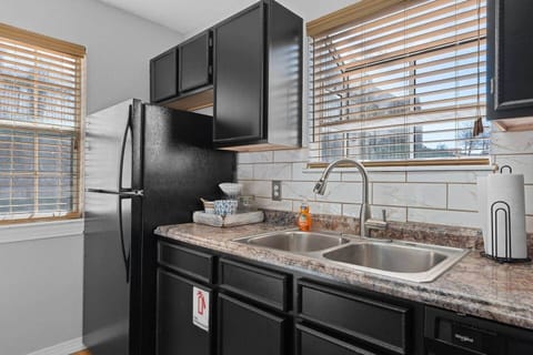 Full kitchen with fridge.