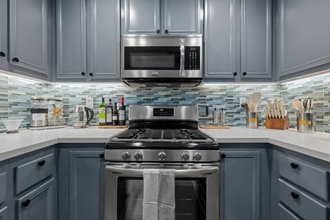 Our sleek metal appliances include a gas stove with oven, microwave, and more, providing everything you need for a modern and efficient cooking experience.