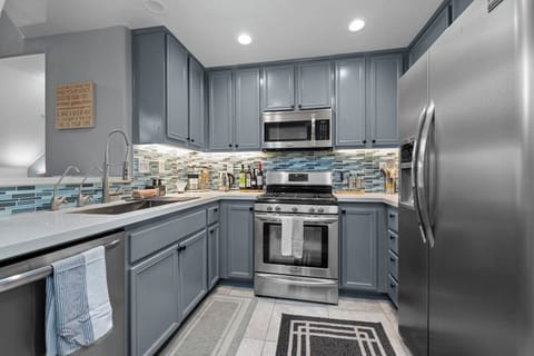 Modern full kitchen featuring sleek metal appliances, combining style and functionality for an exceptional cooking experience.