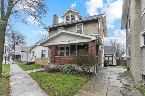 Stunning exterior of the house showcasing a beautiful front design, lush greenery surrounding the area, and a people-friendly walkway—creating a welcoming, vibrant atmosphere that blends modern style with natural beauty