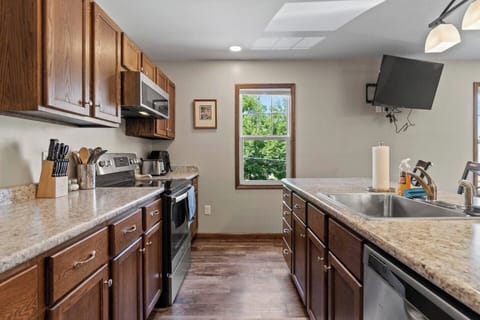 Fully equipped kitchen with a spacious countertop and ample cabinets, providing plenty of storage and space for all your cooking needs.