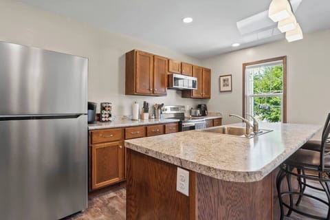 Full kitchen view showcasing modern appliances, a spacious countertop, and plenty of storage, perfect for cooking and entertaining.