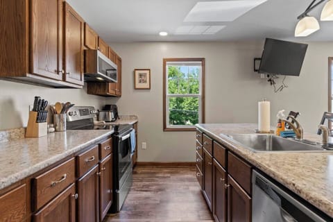 Fully equipped kitchen with a spacious countertop and ample cabinets, providing plenty of storage and space for all your cooking needs.