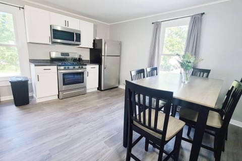 Stylish 6-seater dining area facing the kitchen, creating an open and inviting space perfect for meals and entertaining.