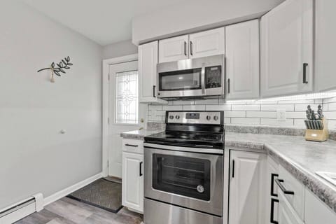Sleek all-white kitchen with modern finishes, creating a bright and clean space for cooking and dining.