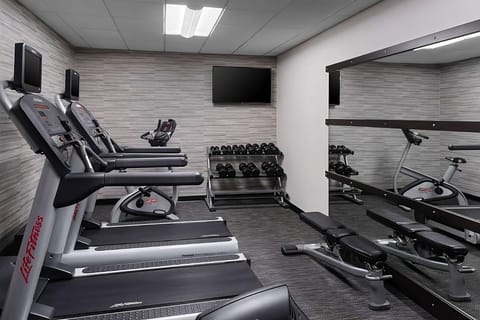 Recharge with a quick workout in the bright, equipped fitness room.