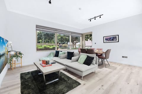 Living Room: Bright and inviting space with lush views, perfect for relaxation or gatherings!