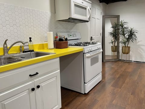 Basement kitchen & access to laundry area with sectional couch & pullout queen.