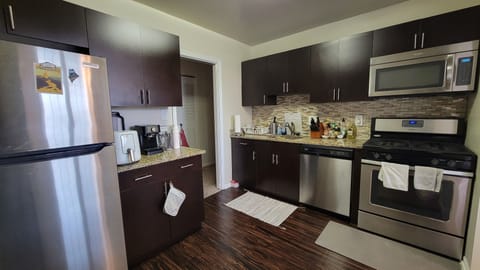 Kitchen includes stove, oven, refrigerator, dishwasher, microwave, and toaster.
