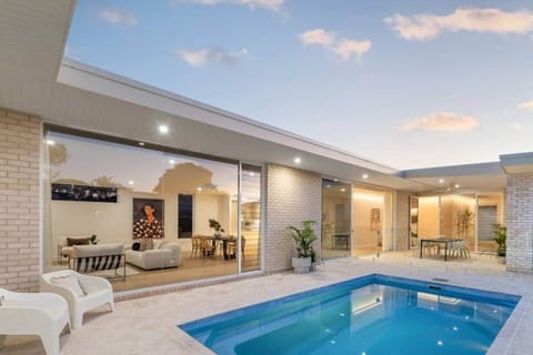 Private heated pool and outdoor living at Modern Beach Haven