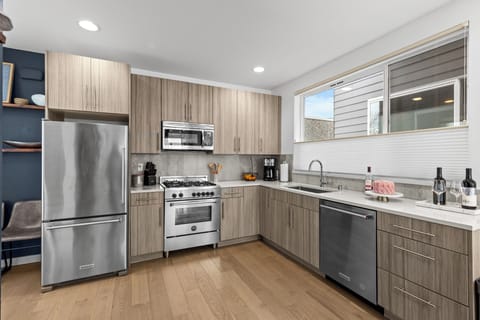 The brightly lit Kitchen has stainless steel applicances with a 4-burner gas range