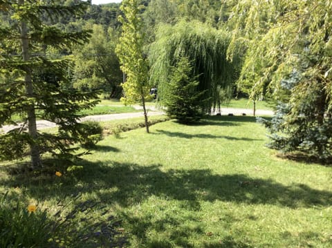 Garden with trees and views over the countryside from the private road
