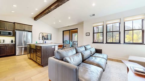 Bright living space with cozy seating and Smart TV