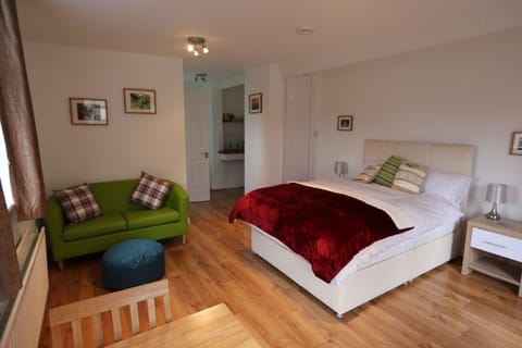 One double bedroom, with sofa and small table and chairs.