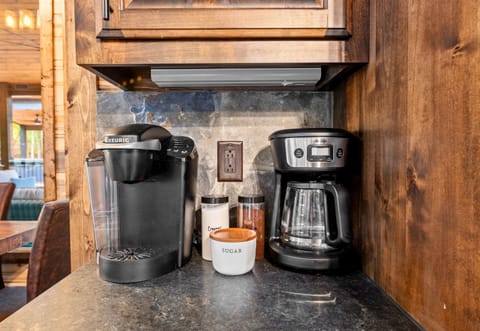 Start your day with a fresh brew from this cozy coffee nook, thoughtfully stocked for all your caffeine needs.