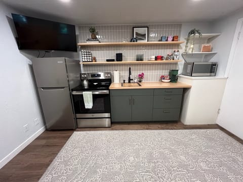 Full kitchen stocked with everything you need to cook and serve a meal.