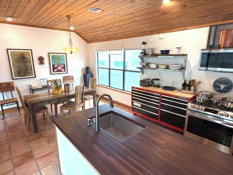 Kitchen opens seamlessly to vaulted dining room for 6