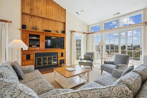 Curl up in your cozy living room with a fireplace, big-screen TV, and panoramic windows framing serene views—your perfect retreat after a day of adventure.