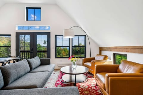 Open-concept living room with comfortable seating and mountain views