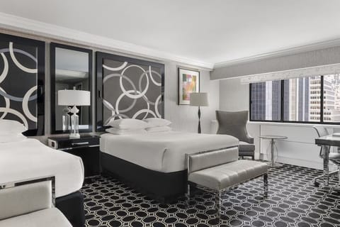 Unwind in plush beds with chic city-side comfort.