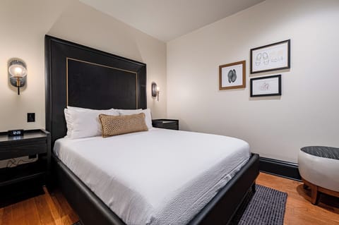 Bedroom 1 - Queen bed featuring a built-in wardrobe and flat-screen TV.