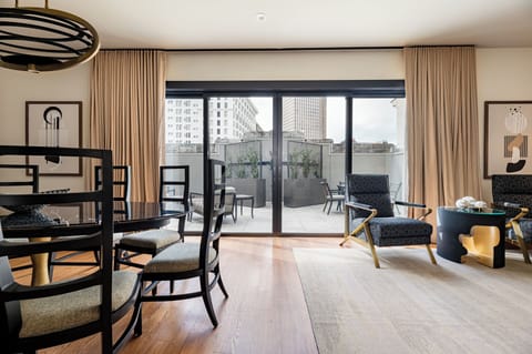 Beautiful penthouse unit seamlessly connecting to a private patio. Neutral decor and bold black accents create a contemporary yet comfortable vibe.