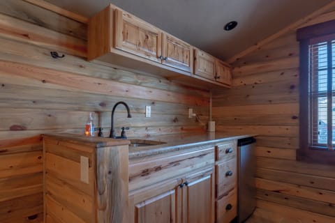 The upstairs living area offers a wet bar, ideal for enjoying drinks and snacks.