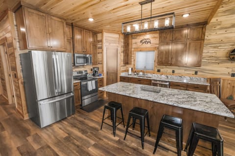 Fully equipped kitchen with large island, bar seating, and lodge style.