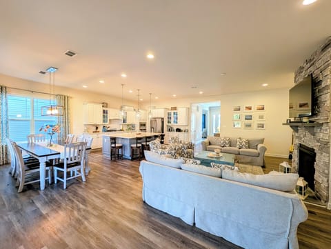 51 Beach Club Avenue - Main Living Area Overview - A wide view of the expansive open-concept floor plan, showcasing the seamless flow between the formal dining area, gourmet kitchen, and cozy family room.