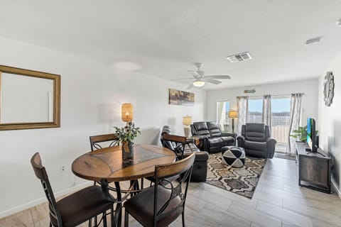 Relax in your spacious open-concept living area, where comfortable leather seating and a dining table create the perfect space for unwinding after your adventures.