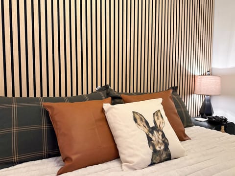 The KING bedroom features a 14" plush mattress and a 55-inch smart TV.