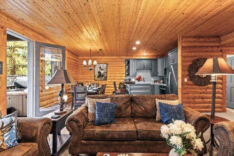 Rustic log cabin living room with cozy stone fireplace and charm.