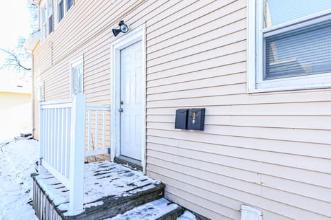 Outside entrance with secure door and motion detector light