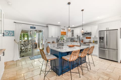 The kitchen features granite countertops, a gas cooktop + new appliances!