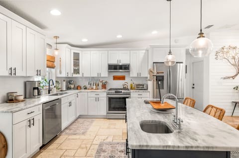 This modern kitchen offers plenty of counter space and a breakfast island for casual dining!