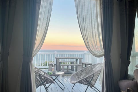 Living Room with double doors out on to Panoramic Seaview balcony 