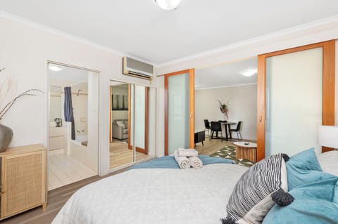 Discover a seamless flow between living spaces in this open-concept layout, connecting the bedroom, living room, and bathroom.