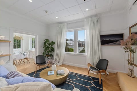 The living area has been beautifully styled and features a backdrop of the Sydney Harbour Bridge.