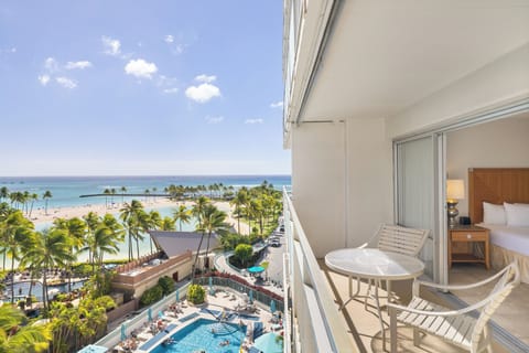 Wake up to breathtaking ocean views, swaying palms, and a sparkling pool below from your private balcony—your tropical retreat awaits.