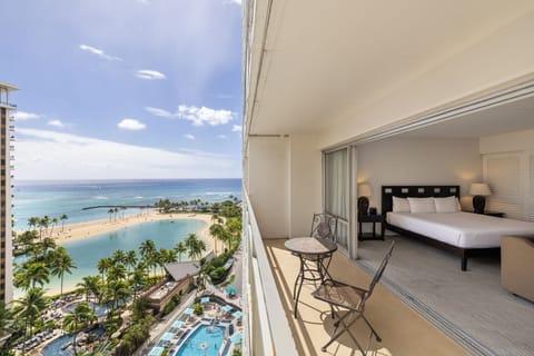 The property features dramatic oceanfront views, overlooking a pristine beach, azure lagoon, and extensive pool area surrounded by tropical palms—part of the scenic resort setting near this vacation rental.