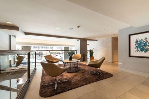 Recharge in a quiet corner lounge overlooking the bright atrium