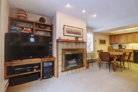 Open concept living area featuring a TV and fireplace.