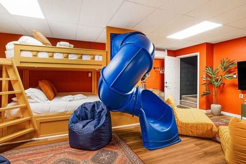 Playroom with 2 full over full bunks and slides