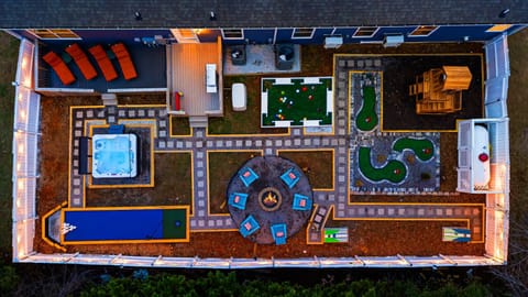 Aerial view of backyard - putt putt, hot tub, bowling, nook ball, fire put and grill