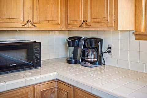 A Keurig with included pods, sugar, creamer and more are provided as well as a traditional coffee maker.