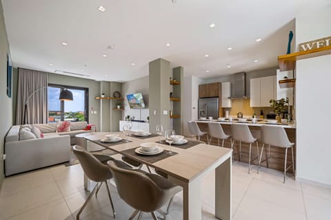 - Gather and entertain in this spacious open-concept living space with stylish dining and lounge area - Thoughtfully designed with sleek furniture and warm lighting for ultimate comfort - Perfect for hosting or simply relaxing with family and friends
