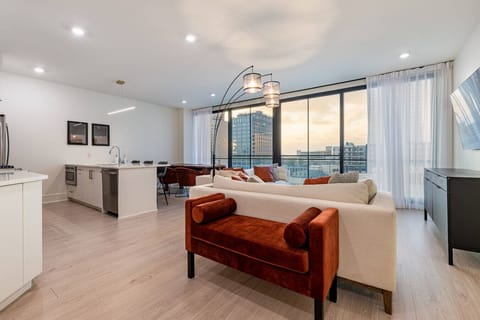 Spacious Open Concept Living Room with Floor to Ceiling Windows